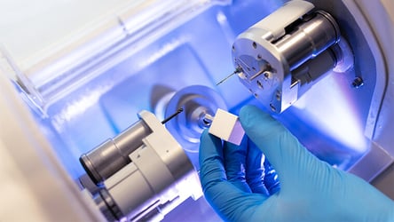 A photograph of a modern CNC machine in a life sciences manufacturing laboratory producing surgical-grade prosthesis
