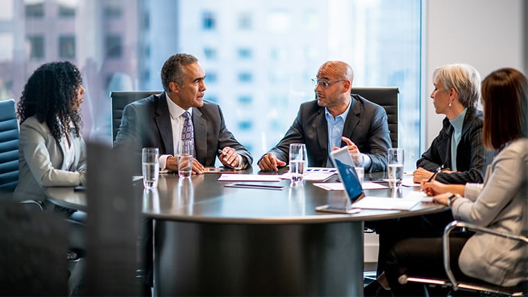 photograph of company leaders discussing the global digital strategy for their manufacturing