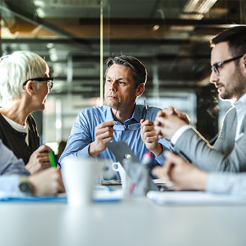 Three business leaders planning systems integration project