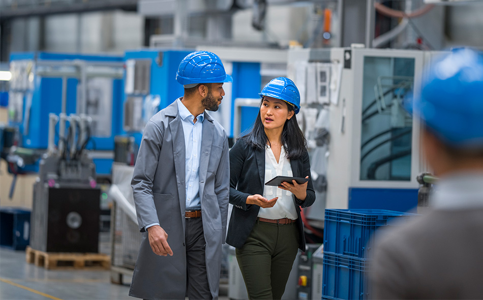 Two digital transformation experts in a manufacturing plant.