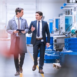 Two engineers taking a plant tour planning for business success optimization using BPO