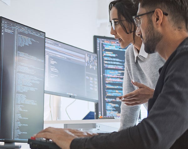 Two engineers working on data architecture to support business success optimization