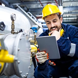 A manufacturing operator using a tablet device to use two manufacturing systems that have been integrated.