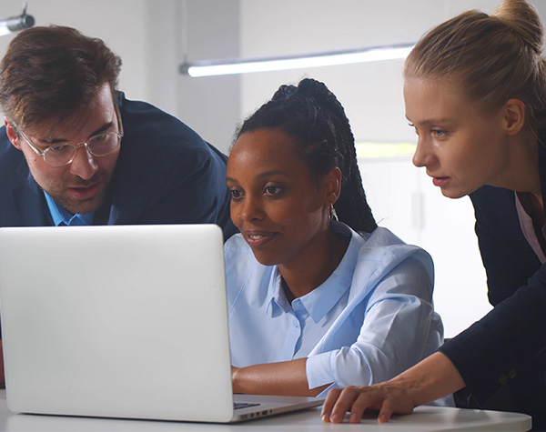 Two engineers and a project manager performing system configuration