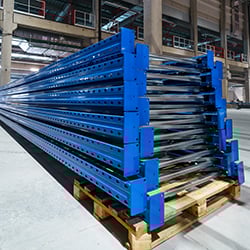Photograph of large metal girders on pallets, a part of the supply chain for industrial uses.