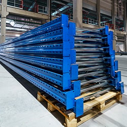 Photograph of large metal girders on pallets, a part of the supply chain for industrial uses.