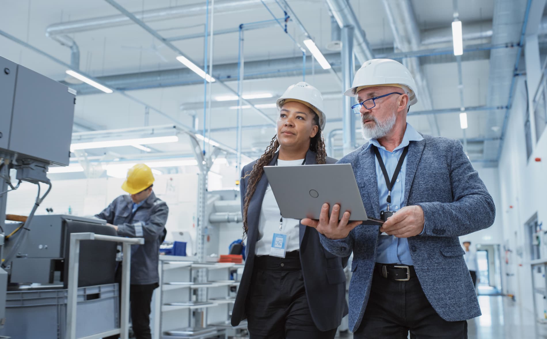 Two manufacturing professionals walking through a facility